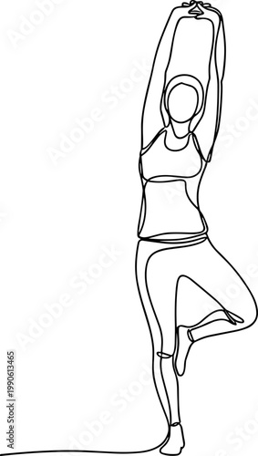 Woman in yoga tree pose standing.