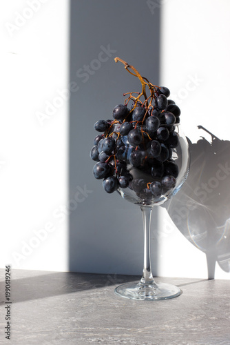 A glass filled with grapes on the table. Table setting. Creative serving of grapes