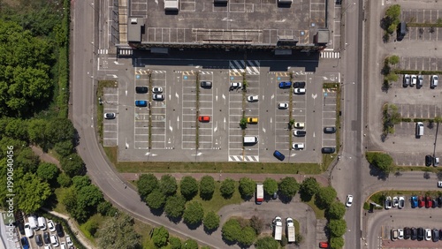 Parking Lot from Above: Aerial view of a well-organized parking area, filled with vehicles. The scene captures the organized structure and utilization of space.