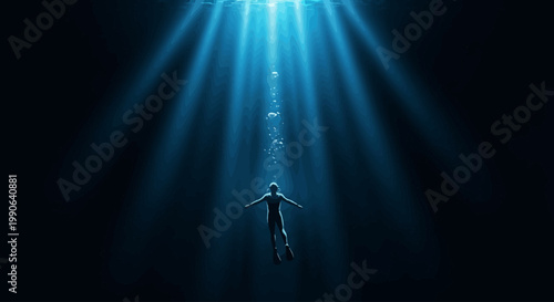 A person swims underwater towards a beam of light in the dark ocean