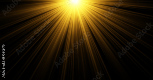Dramatic golden sun rays and radiant light beams shining from top on black background