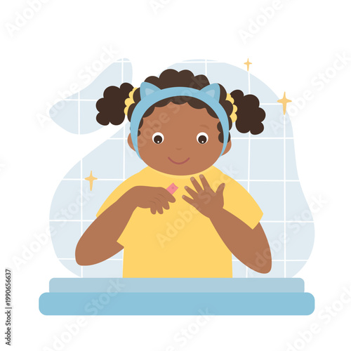 Smiling cute cutting nails to child. Happy african american girl uses clippers for cutting nails.