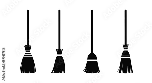 Four black witch brooms stand upright against a plain white background silhouette
