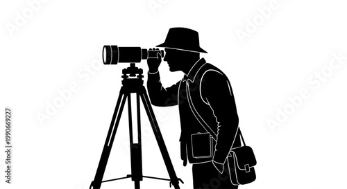 Silhouette of a man wearing a hat, looking through a telescope or long-lens camera on a tripod, with a shoulder bag.