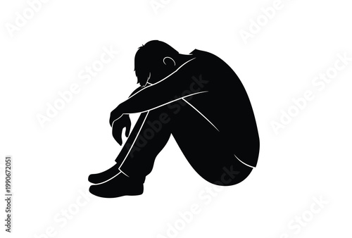 A solitary figure sits huddled in despair a poignant black silhouette