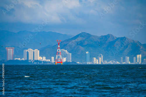 Quadro su tela Panorama of the tourist resort city of Nha Trang in Vietnam with a cable car acr