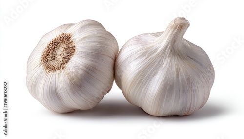 Two whole bulbs of white garlic on a clean white background
