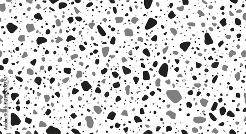 A monochrome pattern of irregularly shaped dark and light gray specks on white