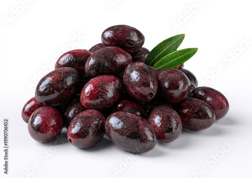 Pile of dark, glossy olives with vibrant green leaves on a white background