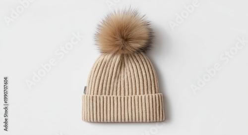 Ribbed knit beanie with fluffy pom-pom on a neutral background