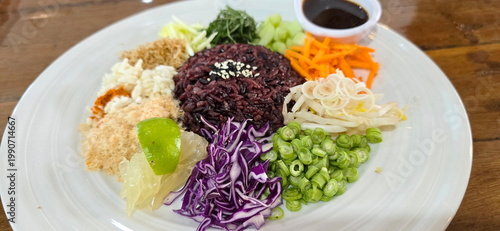 Khao Yam (Thai Rice Salad) is deconstructed vegetables rice salad that emphasizes fresh herbs, vegetables, unique savory dressing or Southern Thai fish sauce. Riceberry Rice, Dried shrimp, mango, pome