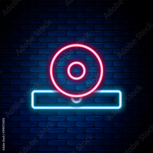 Glowing neon line Otolaryngological head reflector icon isolated on brick wall background. Equipment for inspection the patient's ear, throat and nose. Colorful outline concept. Vector