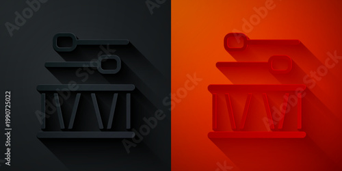 Paper cut Drum with drum sticks icon isolated on black and red background. Music sign. Musical instrument symbol. Paper art style. Vector