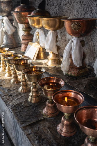Thiksey, India - September 12, 2024: Close-up of butter lamps at Thiksey monastery.