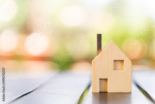 The image from the mirrorless camera shows a house model in the public park for a loans real estate concept.