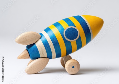 Wooden striped toy rocket on wheels, ready for imaginary space flight