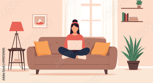 Young woman sitting cross-legged on a comfortable brown sofa and working on a laptop in a stylish living room interior.