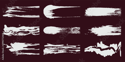 Set of grunge white paint brush strokes and distressed ink textures isolated on dark background for artistic design elements