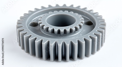 Two interlocking gray plastic gears, one large, one small, on white background