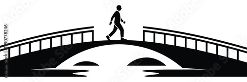 Man walking across an arched stone bridge silhouette