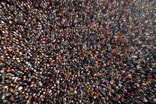 High angle view of a massive crowd of people gathered in a public space, creating a dense and vibrant human tapestry.