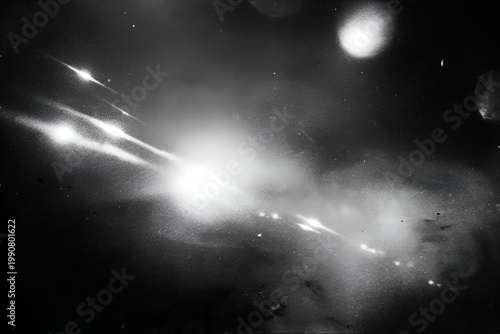 Abstract black and white light streaks and flares on dark background.