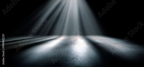 Dramatic Light Rays Illuminating a Dark Stage Floor with Fog and Dust Particles.