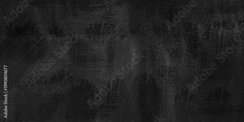 Dark black charcoal wall or grunge textured background with rough black surface and abstract patterns