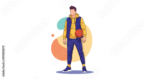 Fashionable young man wearing a yellow hoodie and blue puffer vest while holding a basketball standing against abstract shapes.
