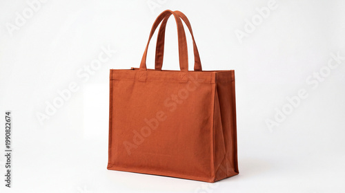 A stylish orange tote bag with two handles on a white background