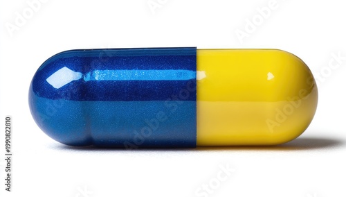 A single blue and yellow capsule isolated against a stark white background