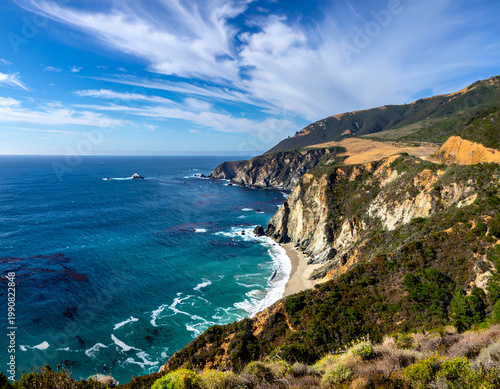 Scenic view of Big Sur coastline with turquoise water and rugged cliffs on sunny day