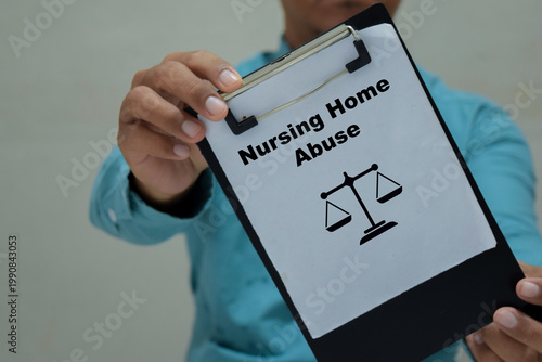 Businessman holds in hands a clipboard with the name of the nursing home abuse.
