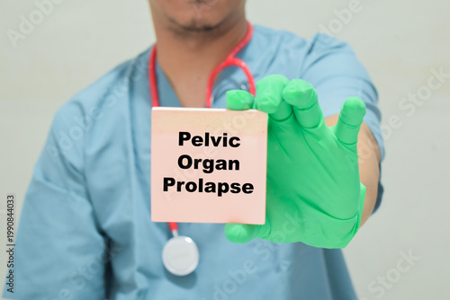 Doctor holds in hands a card with the name of the pelvic organ prolapse. Medical concept