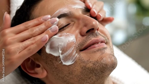 Man receiving facial treatment at spa with calming expression  