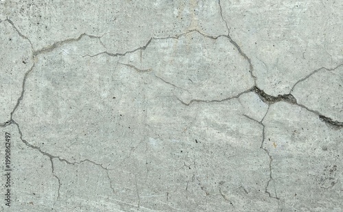 ​Top view of cracked concrete surface with deep fissures and crazing texture