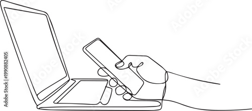 A hand holding a smartphone next to an open laptop isolated on white background