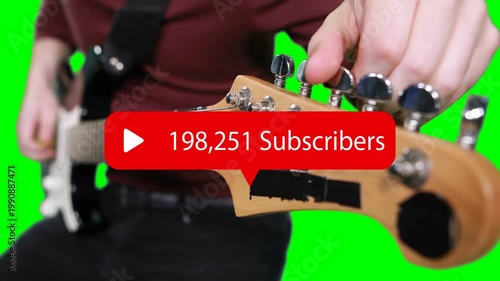 Musician tuning headstock on green, overlay appearing centered and updating with rising subs count
