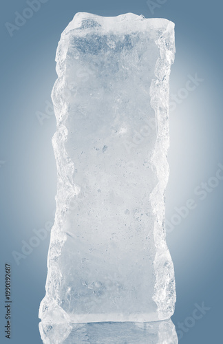 Rough textured ice block, isolated on a blue background.