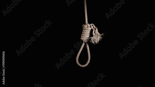 rope noose with hangman knot in front of dark background. suicide loop. suicide loop. the gallows. the loop dangles. rope noose with hangman knot in front of dark background,