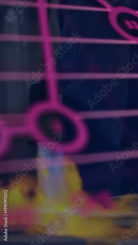 Adult moving near stage while burner nozzle sparking flame and magenta tech charts rising over legs