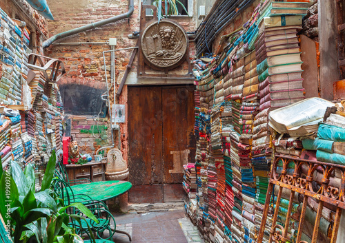Old courtyard with stacked books in Venice, Italy