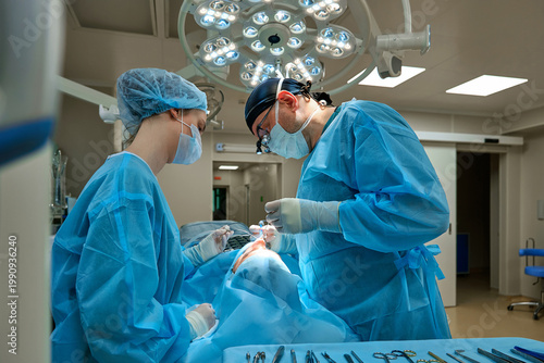 plastic surgeon performs surgery in the operating room