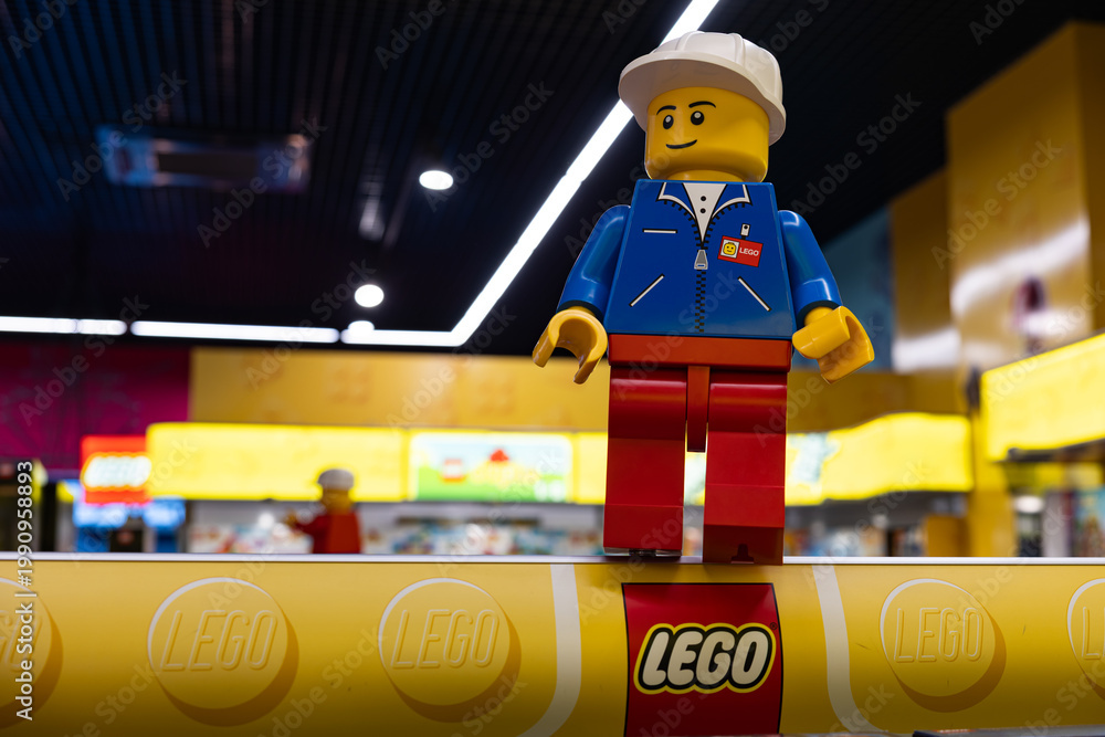 Fototapeta premium LEGO worker minifigure on yellow display shelf in store