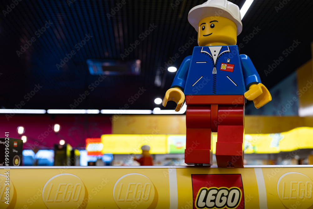Fototapeta premium LEGO worker minifigure on yellow display shelf in store