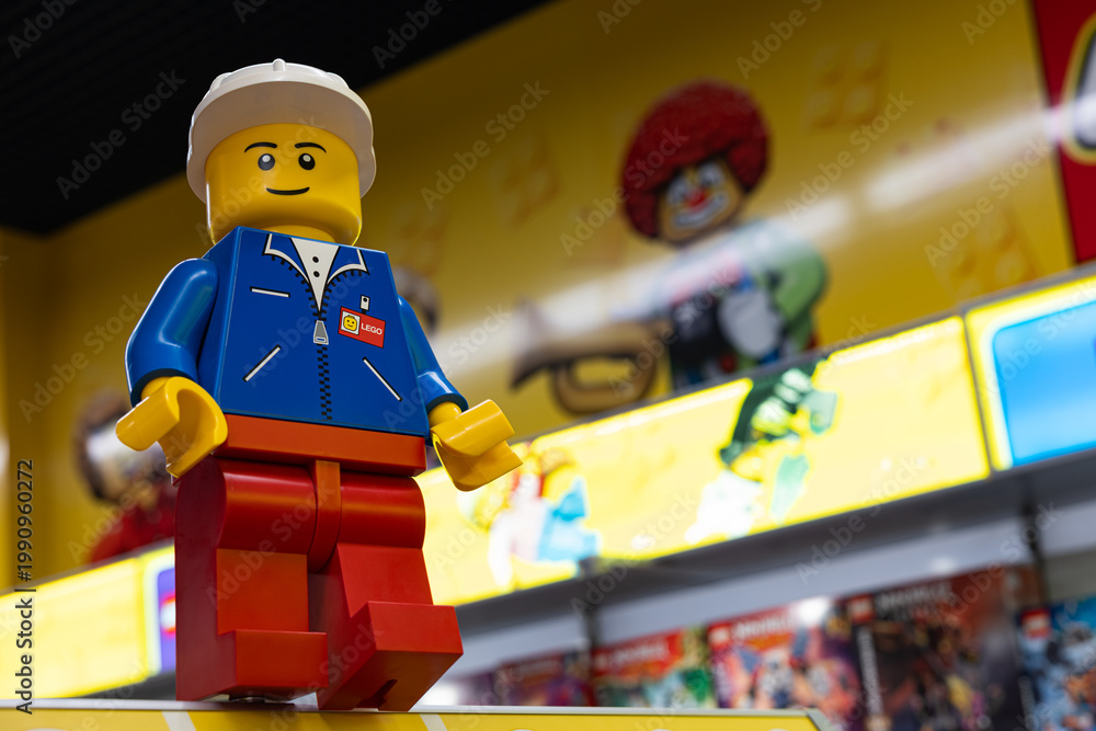 Fototapeta premium LEGO worker minifigure on yellow display shelf in store