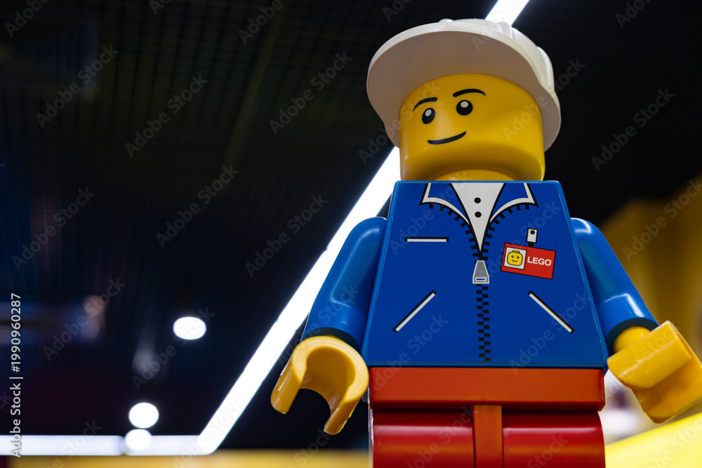 Fototapeta premium LEGO worker minifigure on yellow display shelf in store