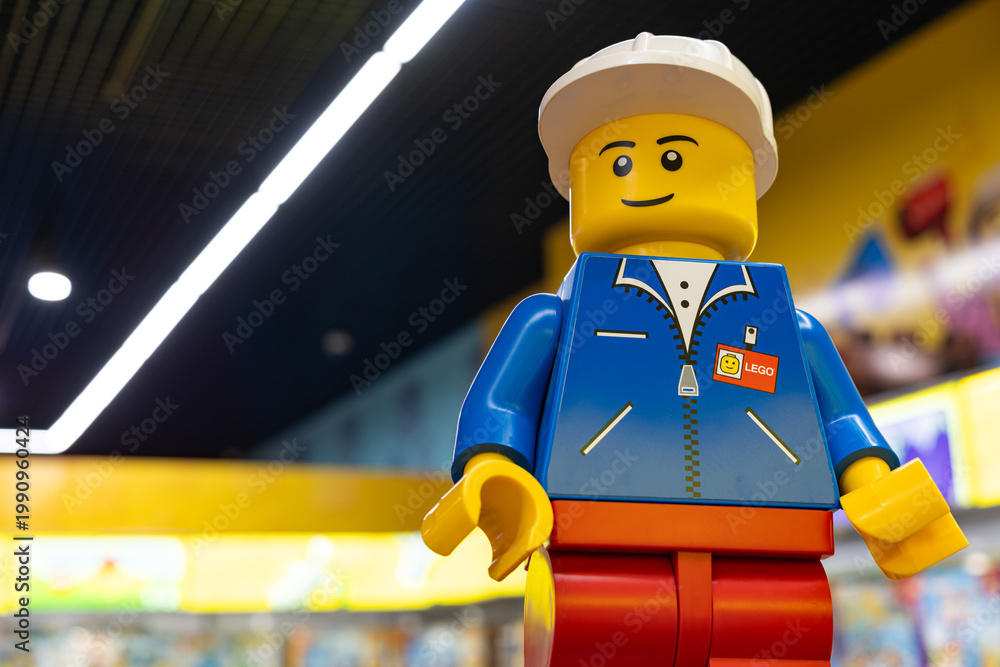 Fototapeta premium LEGO worker minifigure on yellow display shelf in store
