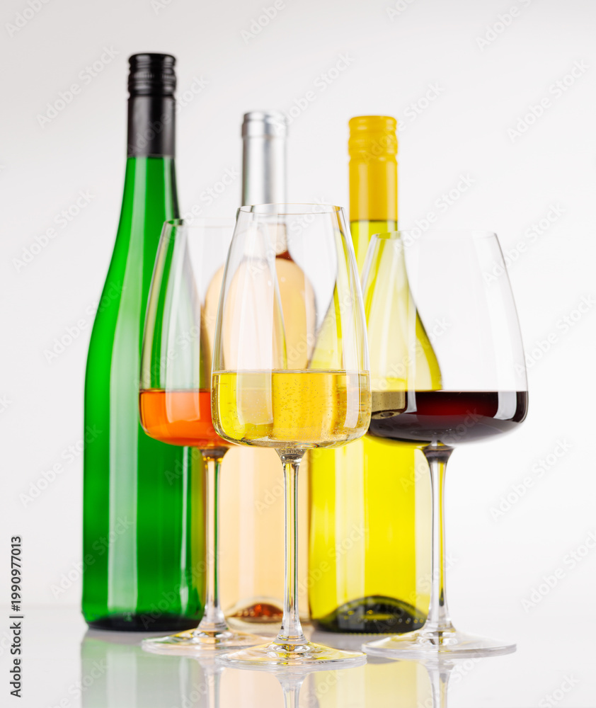 Fototapeta premium Different wine bottles and glasses on white background