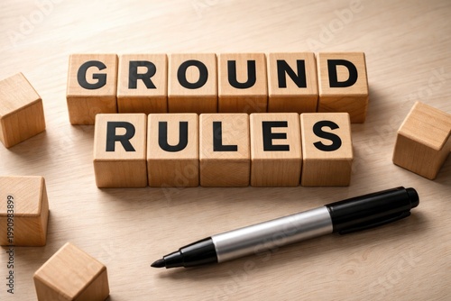 Marker and wooden blocks forming ground rules on a subtle light surface
